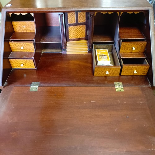 1381 - An 18th century style mahogany bureau, 66 cm wide, and a pair of mahogany two tier tables (3)