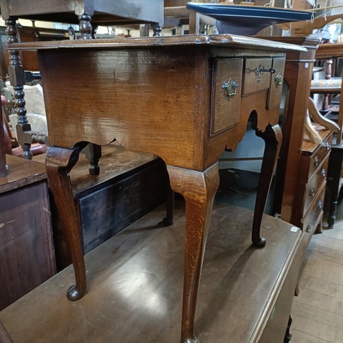 1362 - An oak lowboy, having three drawers, 75 cm wide