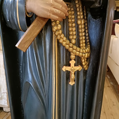 1469 - A carved wood and painted figure of a saint holding a crucifix, 145 cm high