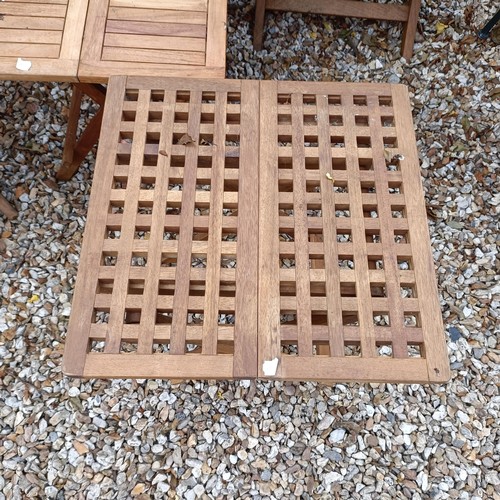 1494 - A set of three teak folding garden chairs, and three folding garden tables