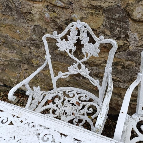 1491 - A painted metal garden table, 110 cm wide, and a pair of armchairs (3)