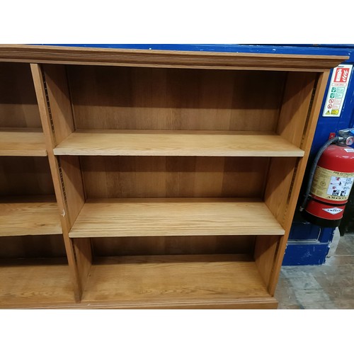 1453 - A light oak bookcase, with adjustable shelves, 113 cm high x 270 cm wide