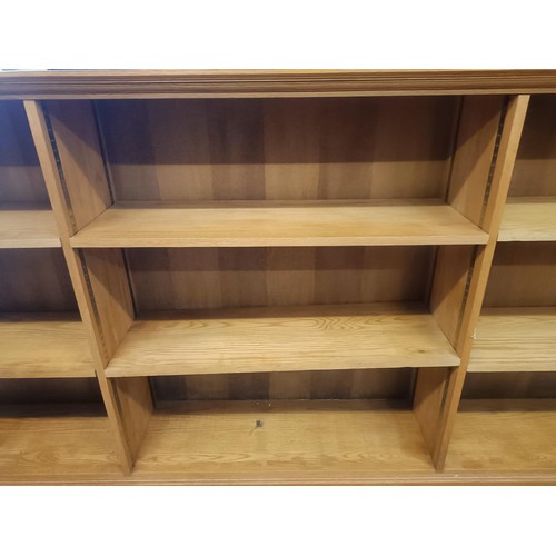 1453 - A light oak bookcase, with adjustable shelves, 113 cm high x 270 cm wide