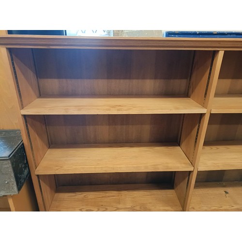 1453 - A light oak bookcase, with adjustable shelves, 113 cm high x 270 cm wide