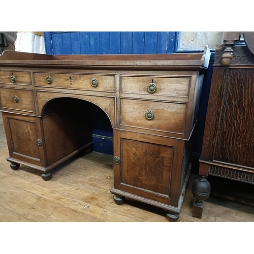 1387 - A Regency mahogany pedestal desk, the top having a raised back, with five drawers, on two squat pede... 