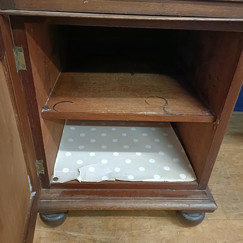 1387 - A Regency mahogany pedestal desk, the top having a raised back, with five drawers, on two squat pede... 