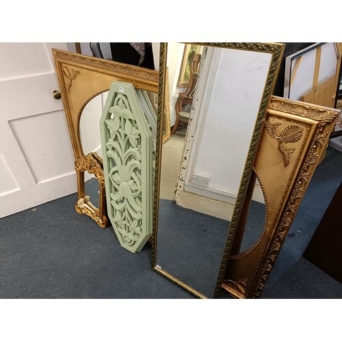 1537 - A gilt framed wall mirror, 110 x 137 cm, two other mirrors, and two painted panels with pierced deco... 