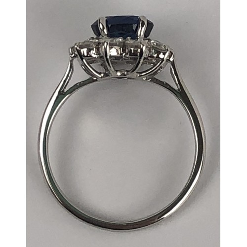 636 - A white metal, sapphire and diamond cluster ring, ring size M