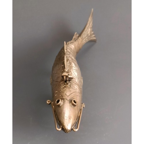 63 - An articulated silver coloured metal fish, with engraved decoration, 16.5 cm