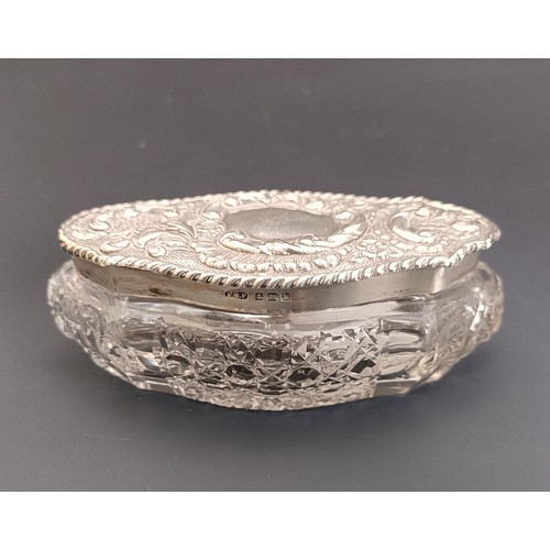 89 - A silver backed mirror, a silver backed brush, and three cut glass boxes, with silver mounts and lid... 