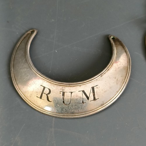 176 - A silver decanter label, Gin, another, Brandy, and a plated decanter label, Rum (3)