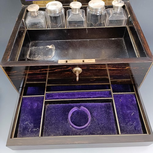 190 - A 19th century coromandel dressing box, the hinged top to reveal a mirror and various silver top bot... 