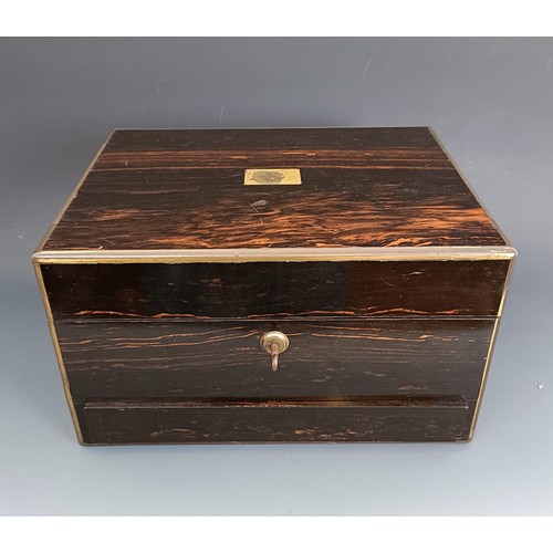 190 - A 19th century coromandel dressing box, the hinged top to reveal a mirror and various silver top bot... 