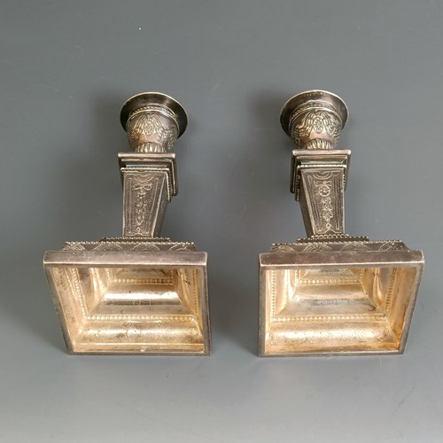 204 - A pair of silver dwarf candlesticks, decorated swags and bell flowers, import marks for London 1977,... 