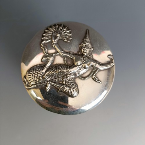 208 - An Indian silver coloured metal box and cover, decorated dancing figures, 12 cm high