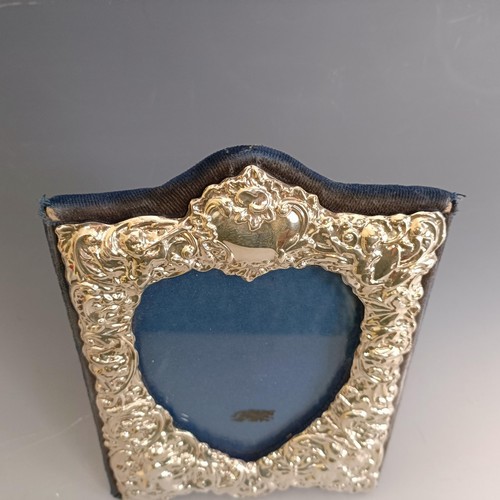 209 - A Victorian style silver mounted strut photograph frame, decorated cherubs, London 1994, 14 cm wide