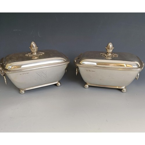 212 - A pair of George III silver dishes and covers, with pineapple style finials and rams mask ring handl... 