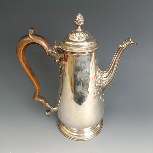 213 - A mid 18th century silver coffee pot, of baluster form, embossed flowers, marks rubbed, probably Lon... 