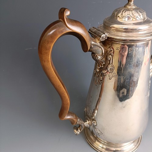 213 - A mid 18th century silver coffee pot, of baluster form, embossed flowers, marks rubbed, probably Lon... 