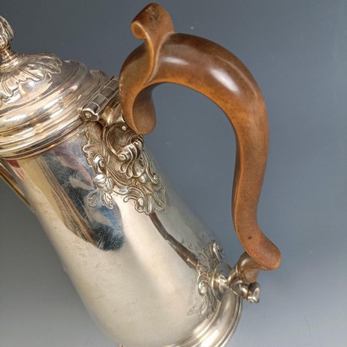 213 - A mid 18th century silver coffee pot, of baluster form, embossed flowers, marks rubbed, probably Lon... 