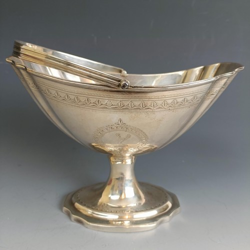 218 - A late 18th century Irish silver swing handled pedestal basket, with engraved decoration, Dublin 179... 