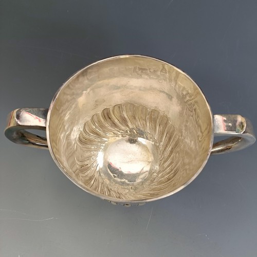 230 - An early 18th century silver two handle porringer, with a gadrooned lower body, London 1726, 11 cm h... 