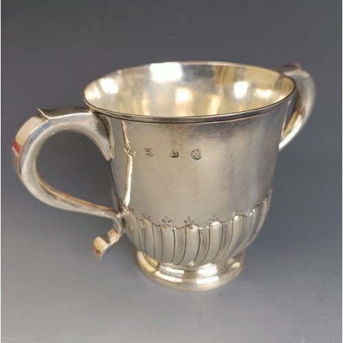 230 - An early 18th century silver two handle porringer, with a gadrooned lower body, London 1726, 11 cm h... 