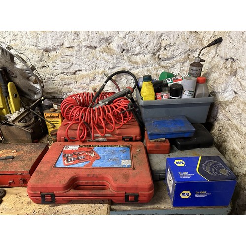 77 - Assorted headlamps oil cans and tools (on top of the work bench)