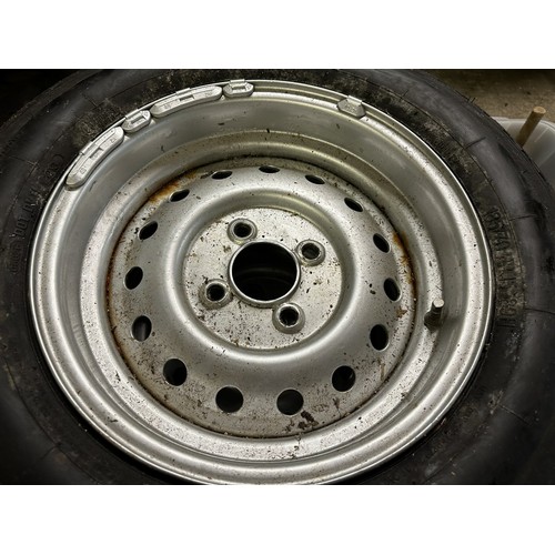 82 - A set of four Triumph TR6 steel wheels, with tyres and hub caps