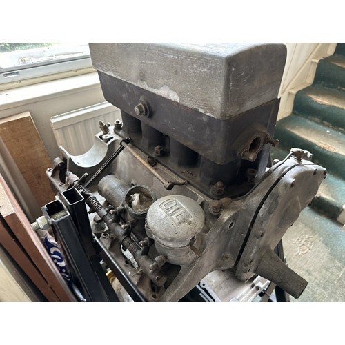 An Alvis engine on a metal stand, and in pieces, understood to be from ...