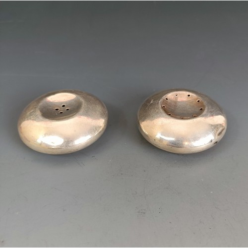 251 - A pair of Danish sterling silver condiments, of compressed circular form, 5 cm diameter