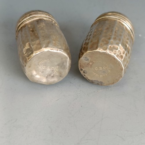 260 - A pair of sterling silver pepperettes, with hammered decoration, 3.5 cm high