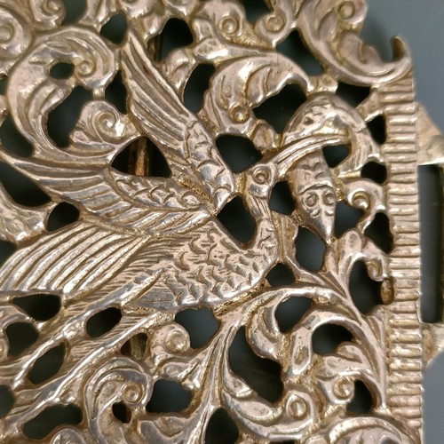 265 - A nurses silver buckle, decorated birds and scrolling foliage