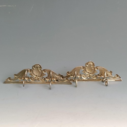 276 - A pair of late Victorian silver menu holders, of scroll form, crested, London 1890, 1.6 ozt (2)