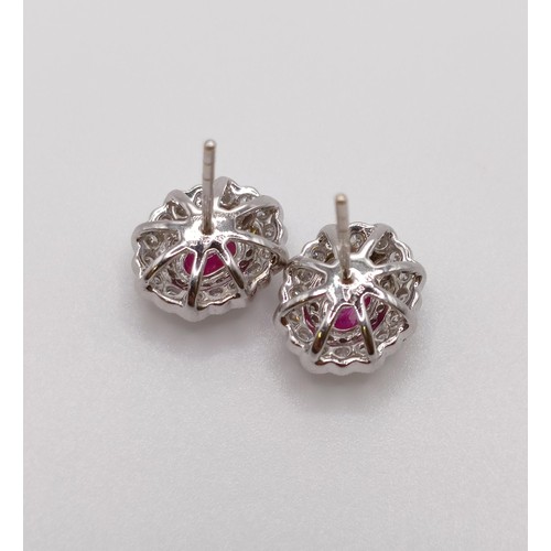 505 - A pair of ruby and diamond stud earrings...