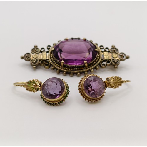 508 - A Victorian purple stone brooch, and a similar pair of earrings...