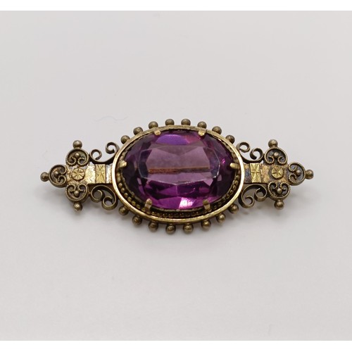 508 - A Victorian purple stone brooch, and a similar pair of earrings...