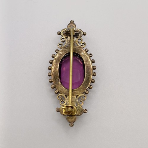 508 - A Victorian purple stone brooch, and a similar pair of earrings...