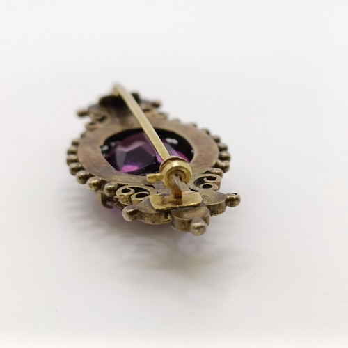 508 - A Victorian purple stone brooch, and a similar pair of earrings...