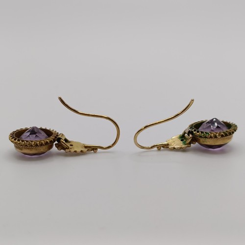 508 - A Victorian purple stone brooch, and a similar pair of earrings...