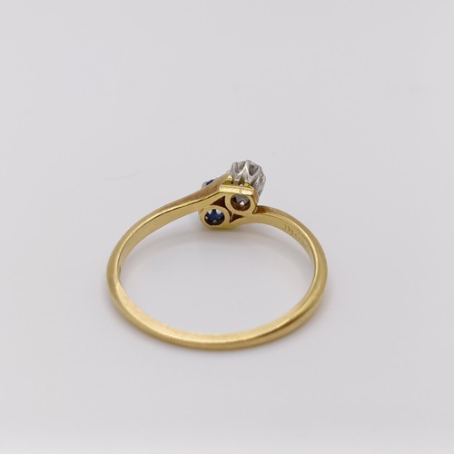 513 - An 18ct gold, diamond and sapphire crossover ring, ring size O