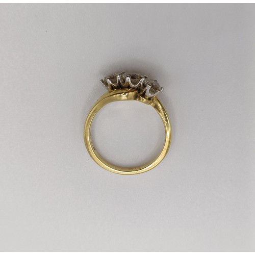 514 - An 18ct gold and three stone diamond ring, central stone 0.3ct approx., ring size K