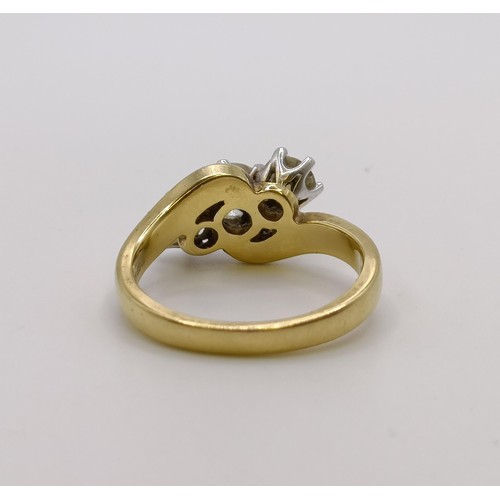 514 - An 18ct gold and three stone diamond ring, central stone 0.3ct approx., ring size K