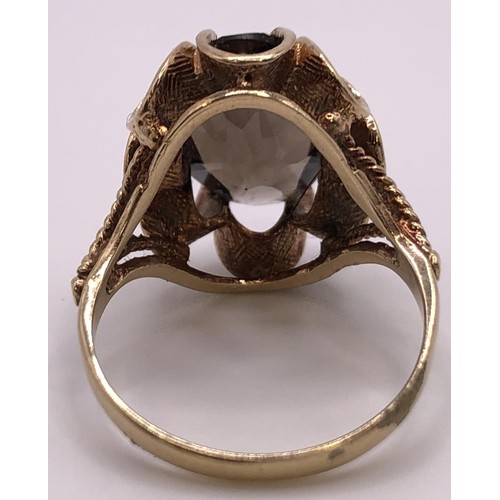 516 - A 9ct gold and brown stone ring, ring size O, and a silver signet ring