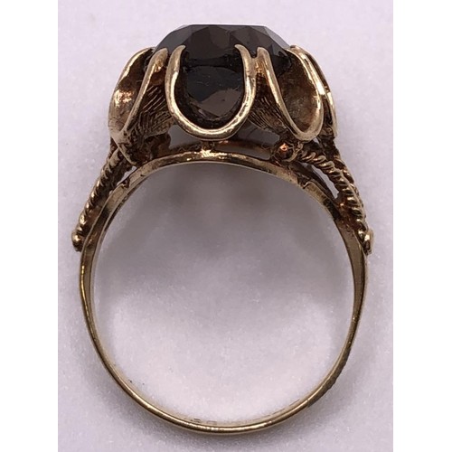 516 - A 9ct gold and brown stone ring, ring size O, and a silver signet ring