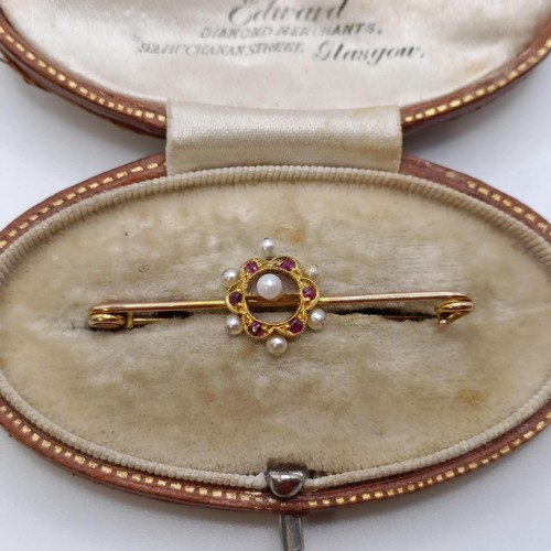 517 - A late 19th/early 20th century seed pearl and red stone bar brooch, in a vintage jewellery box, with...