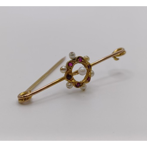 517 - A late 19th/early 20th century seed pearl and red stone bar brooch, in a vintage jewellery box, with...