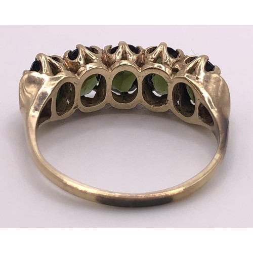 518 - A 9ct gold and green stone five stone ring, ring size L