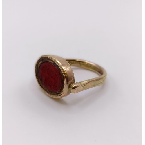 526 - A 9ct gold and carved red stone intaglio ring, decorated a portrait, ring size N approx....