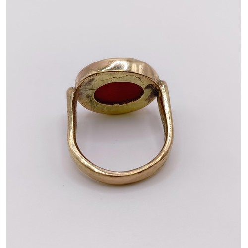 526 - A 9ct gold and carved red stone intaglio ring, decorated a portrait, ring size N approx....